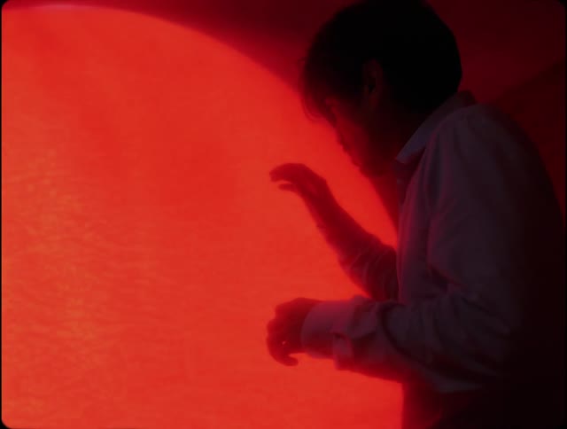 Man facing an abstract red dimension