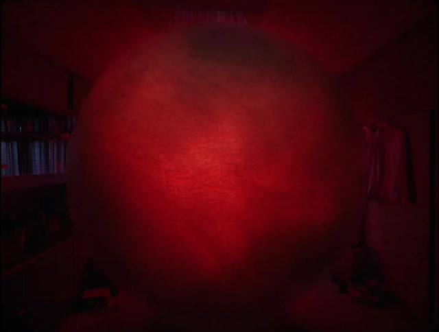A giant orb is glowing red in the room