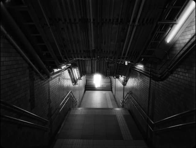 A person in ghost form like light walking down the stairs