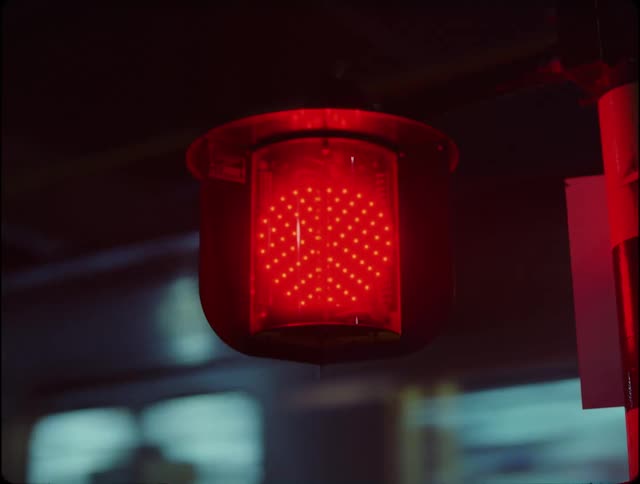 Closeup of a red siren with the train passing in the background