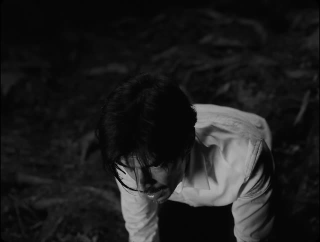 Portrait of a person crouched on the ground in fear