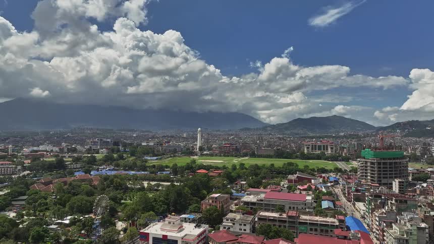 Panorama of a thirdworld city with green fields and mountains on the horizon