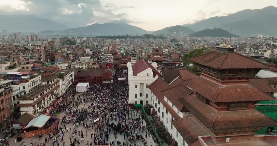 People moving around in a city square at midday