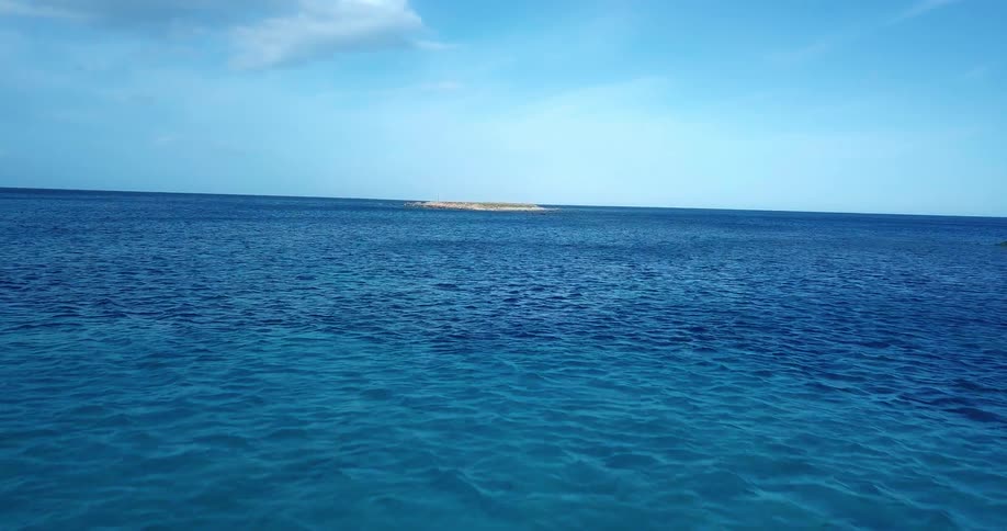 Panorama of the sea with an island on the horizon