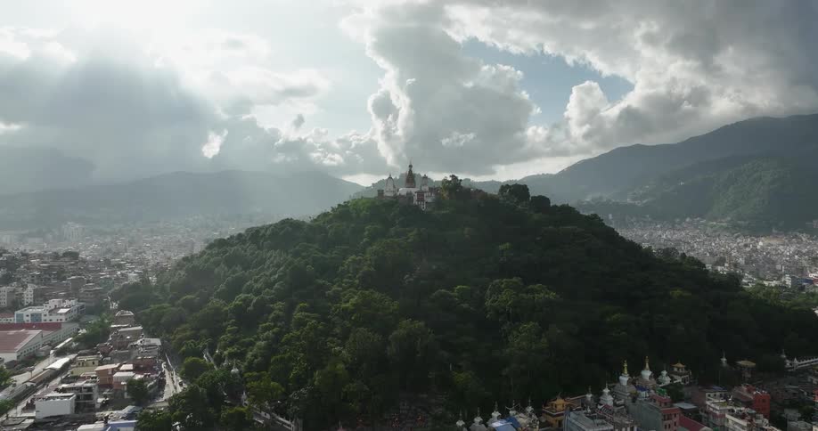 Hill top temple surrounded by neighborhood on cloudy day