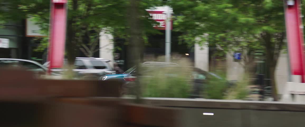 Blue car drives on the city streets at daytime