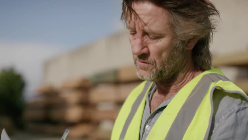 Worker wearing a yellow vest while working