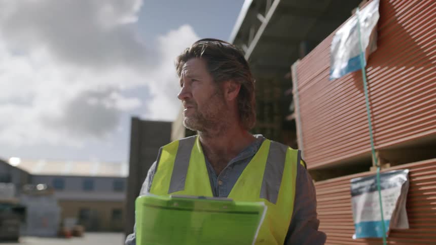 Worker wearing a yellow vest while working