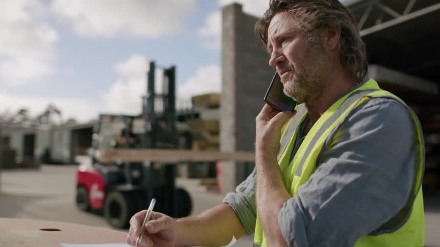 Worker wearing a yellow vest while working