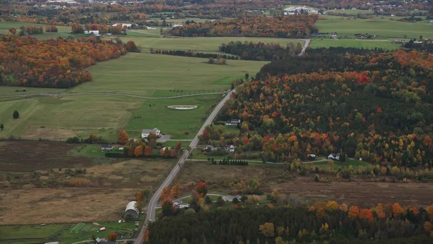 An aerial panorama of some residential houses amidst rural areas rich in vegetation