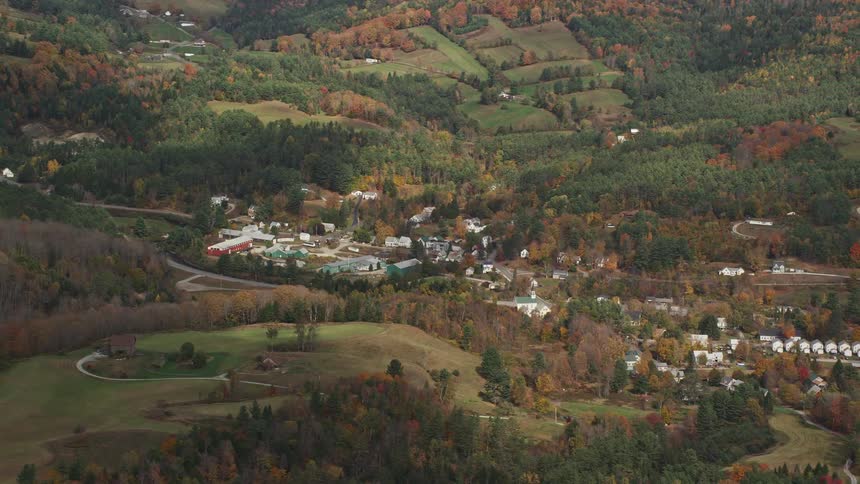 Aerial view of rural neighborhood and trees with fall colors
