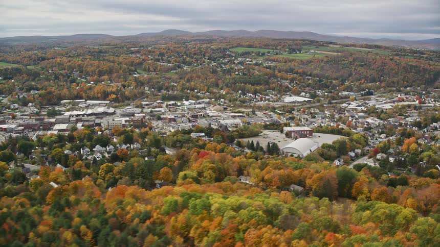 Aerial view of a town near a forest during autumn