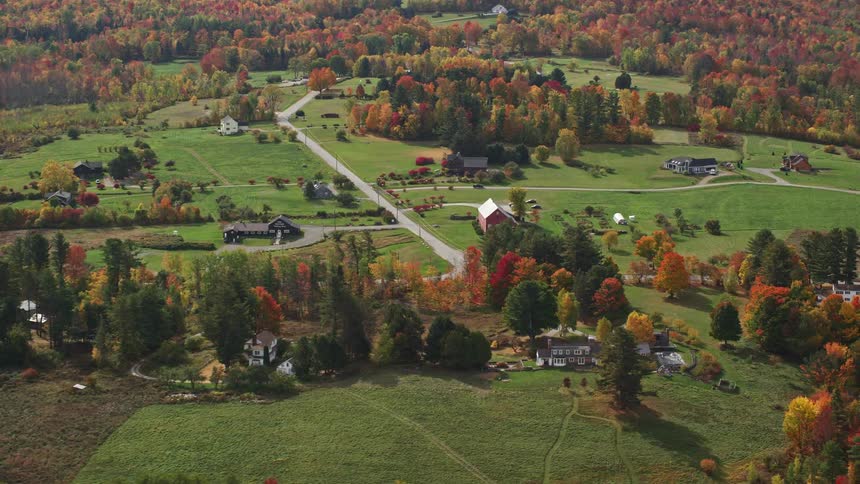 Aerial view of houses and farms in the fields at autumn