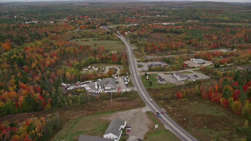 A rural area with a huge road passing through forests