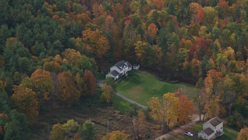 Aerial view of a house surrounded by forests in the countryside