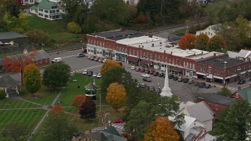 Aerial view of a neighborhood with a central brick building surrounded by trees