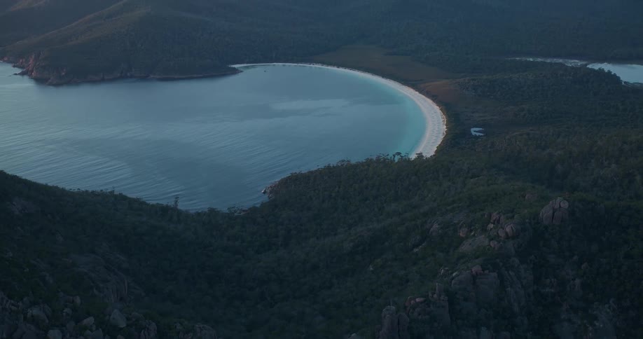 Aerial view of a beach next to the mountains at morning