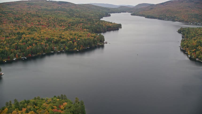 Several pieces of land with trees and a huge river between them