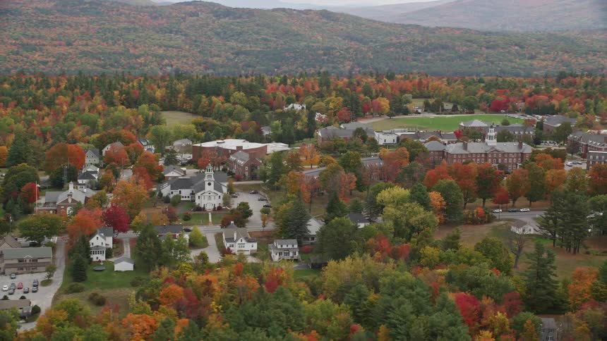 A small country town with a monastery and lots of trees nearby