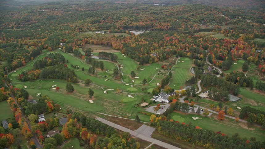 An aerial panorama of houses in an upscale environment surrounded by green areas