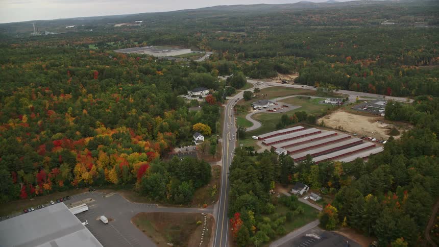 Aerial view of rural area in fall color buildings and road