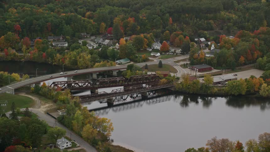 Bridge over river near rural neighborhood in fall