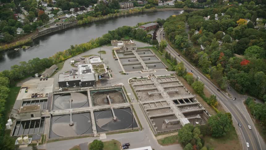 Aerial of urban neighborhood with river and forest