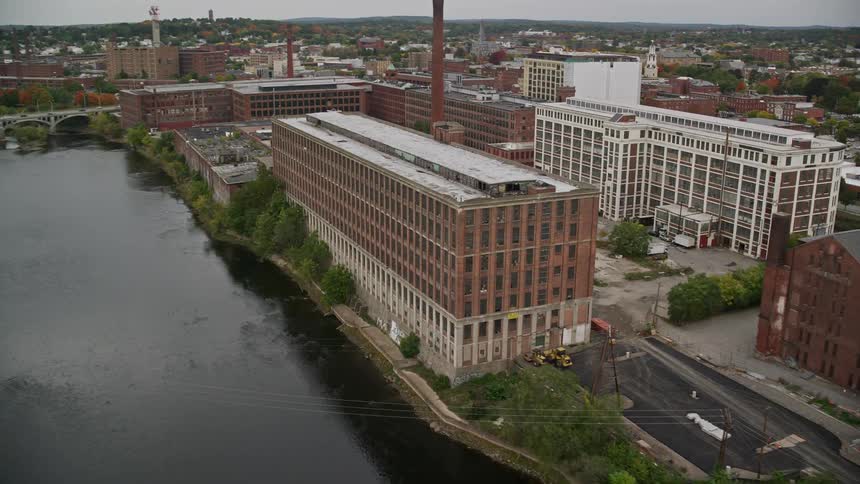 Aerial of an old building next to a river in an urban city