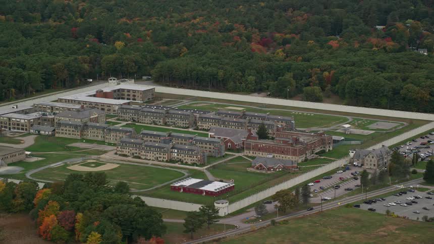 An aerial view captures trees with vibrant fall foliage near the massachusetts correctional institution cedar junction in walpole massachusetts
