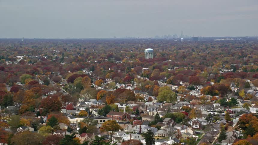 A residential area of town with trees with red leaves