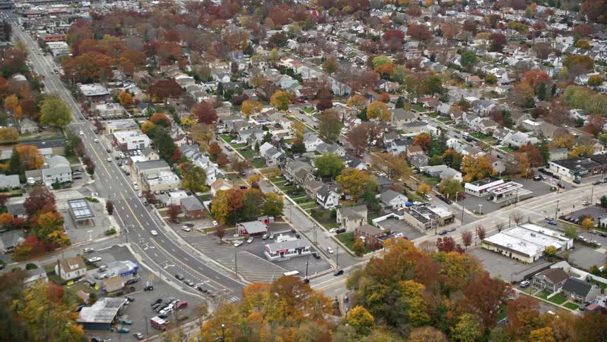 Aerial view of a residential neighborhood by the side of a highway