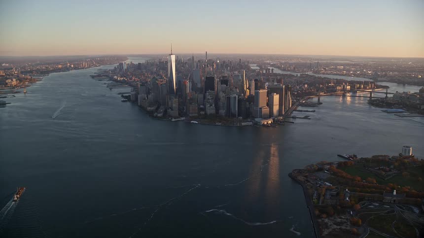 Skyscrapers and buildings at waterfront in new york city at sunset