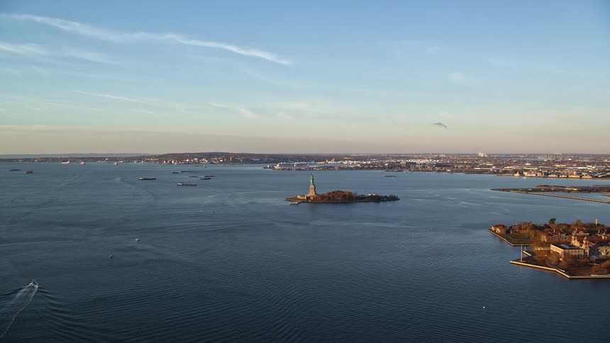 The statue of liberty in new york on an island surrounded by a sea