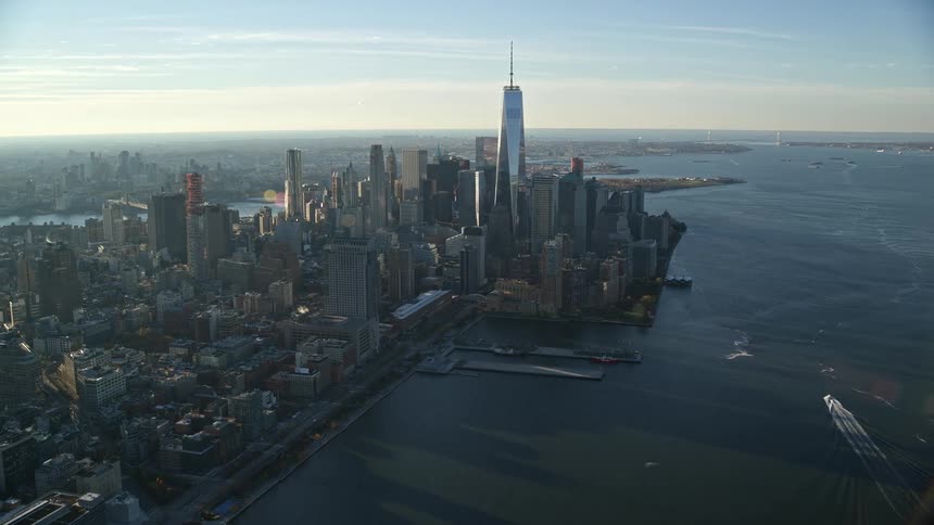 The numerous tall sky scrapers of new york city crowd the shoreline