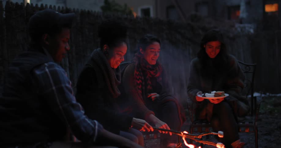 People are roasting marshmallows on a campfire