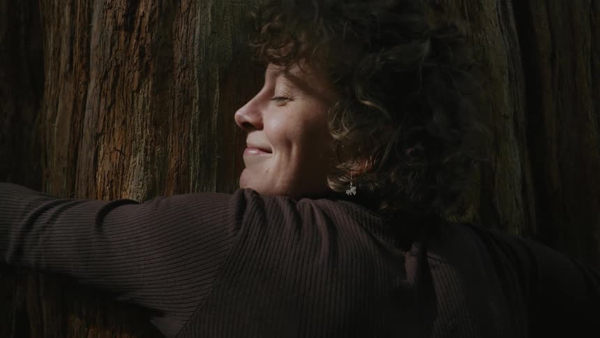 Woman hugging a tree