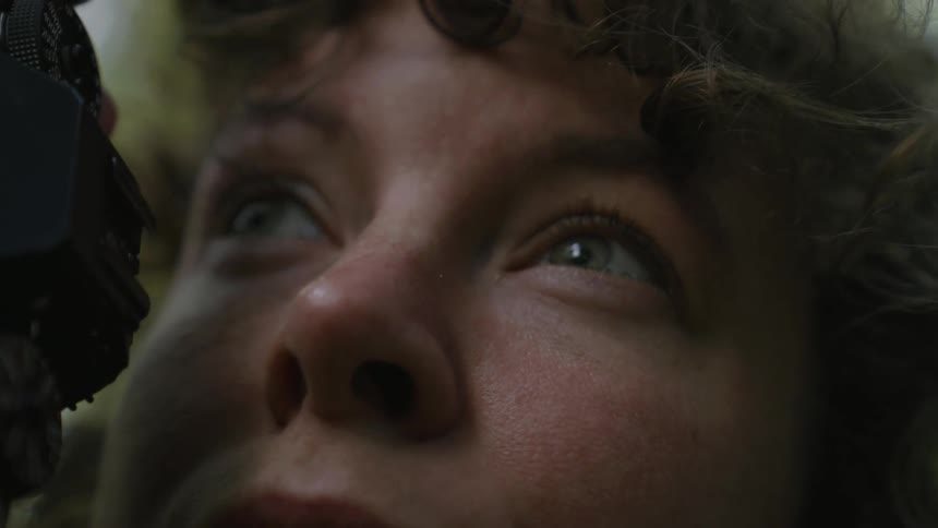 A close up of a young woman taking photos