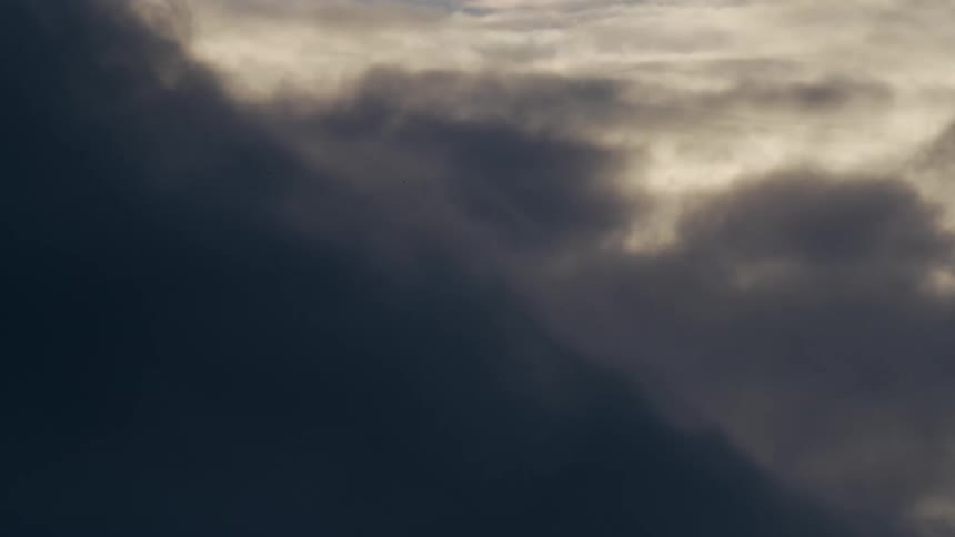The sky covered in gray clouds during the evening