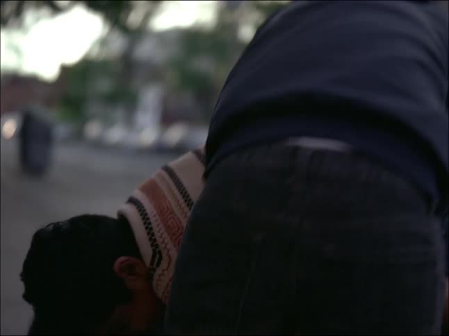 Three young boys are playing and one of them is on top of his friends back