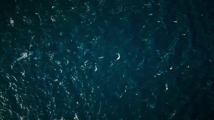 Slowmotion aerial view of the sea with calm waves