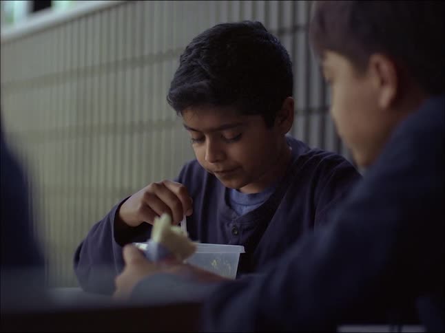 Two child workers eating and talking