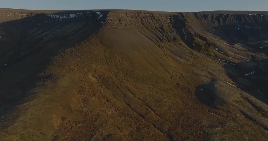 Aerial view of mountains with a light dusting of snow