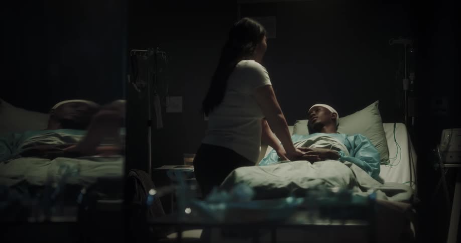Woman visiting patient lying in hospital bed takes her leave