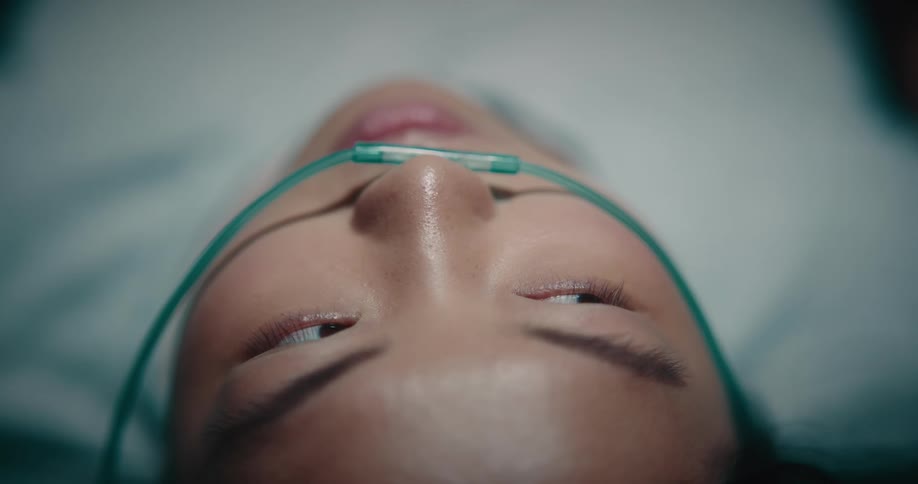 Closeup of a woman with a nasal cannula for administering oxygen