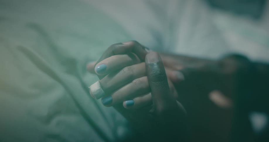 Closeup of two hands holding each other and caressing them