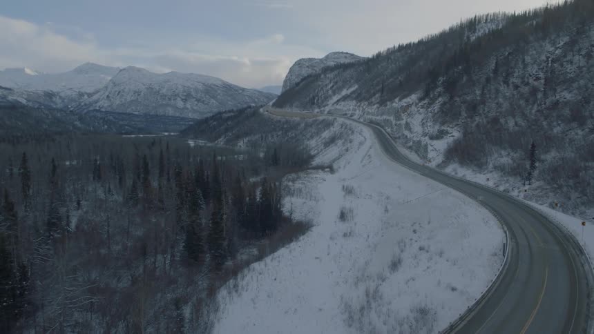 Slow traverse over a twisting mountain valley highway