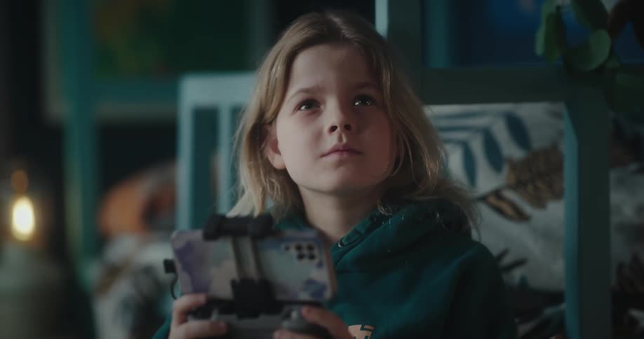 Young girl uses controller to operate drone