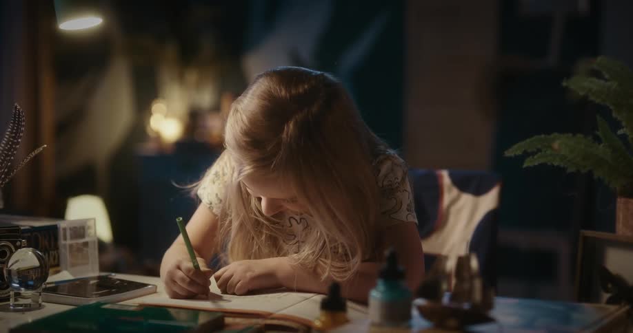 A girl doing her schoolwork at the office table
