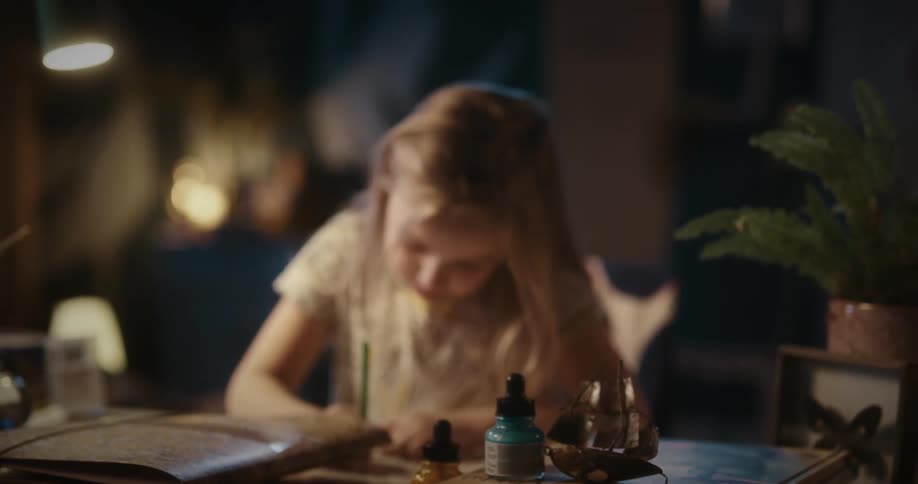 A child is drawing at the desk