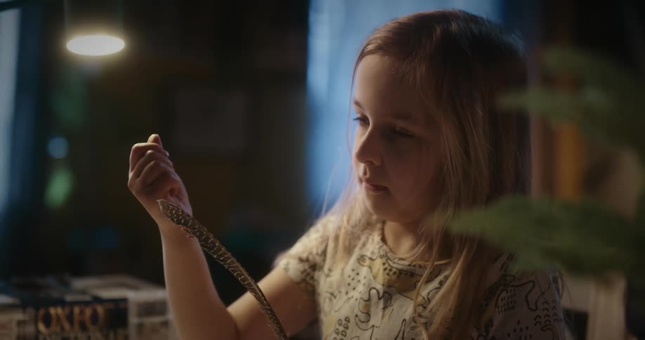 A child is touching a feather
